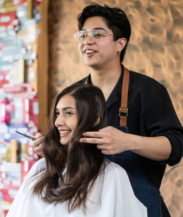 Lady browsing hairdressing products on shelf