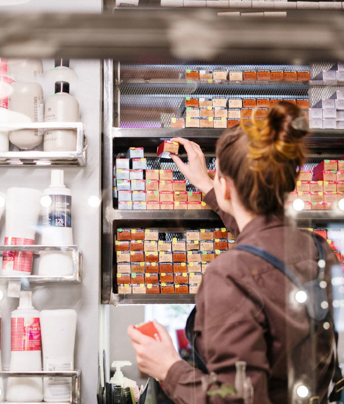 Lady looking at a shelf of hair supplies