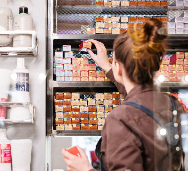 Woman Browsing Hair Products on Shelf